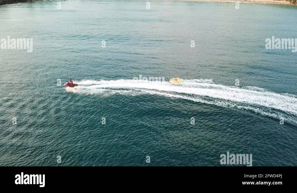 Jet ski towing a raft of people near the beach of Kenting, Taiwan Stock