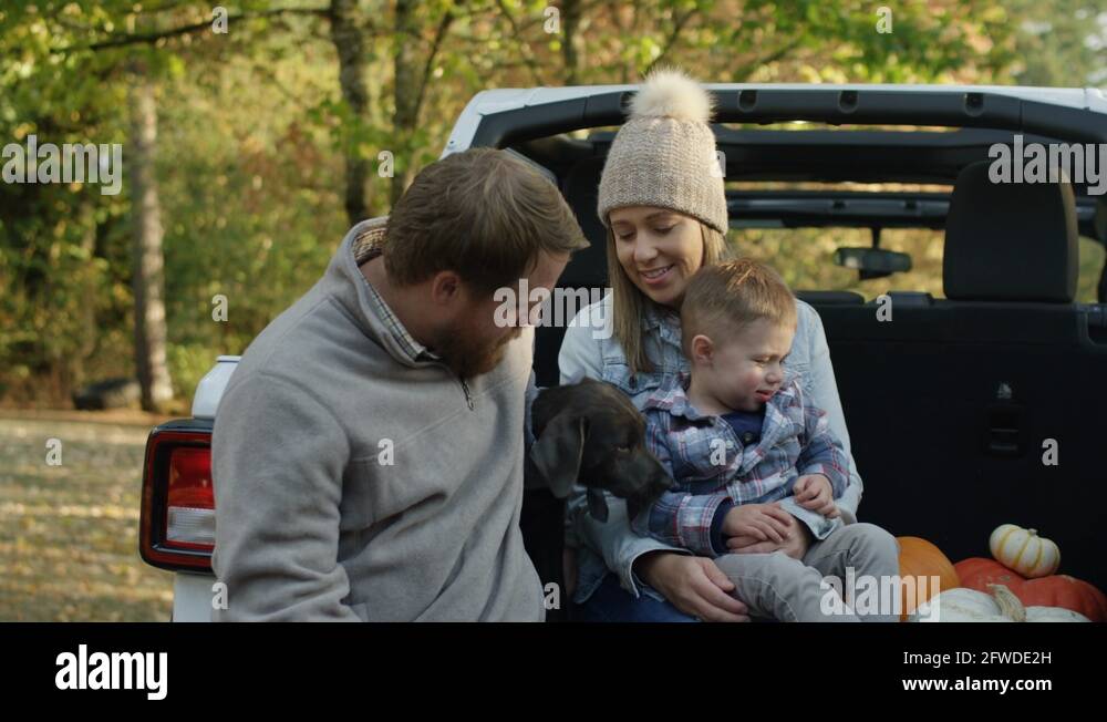 Happy Family Sit In Back Of SUV Mom Holds Her Little Boy Puppy Licks happy-family-sit-in-back-of-suv-mom-holds-her-little-boy-puppy-licks