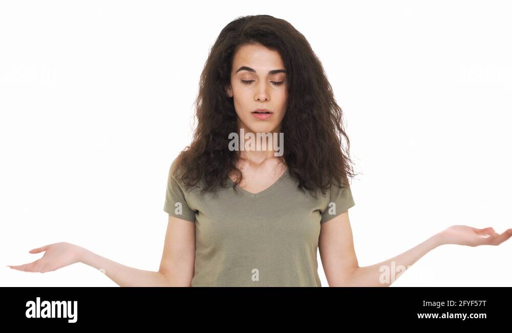 Portrait Of Hispanic Woman With Cunning Look Shrugging And Throwing 