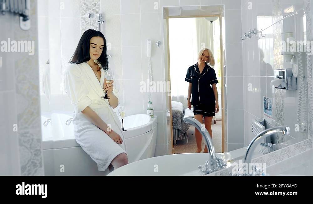Two Young Women Lesbians Drink Champagne And Laugh In The Bathroom Stock Video Footage Alamy