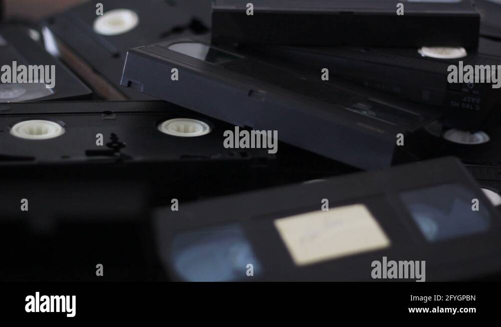 Take a vhs cassette tape from a stack of tapes Stock Video Footage Alamy