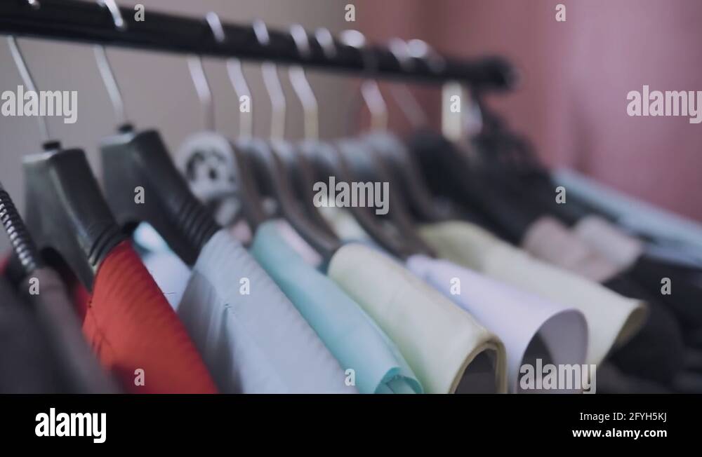 Row of clothes on hangers in shop Stock Video Footage - Alamy