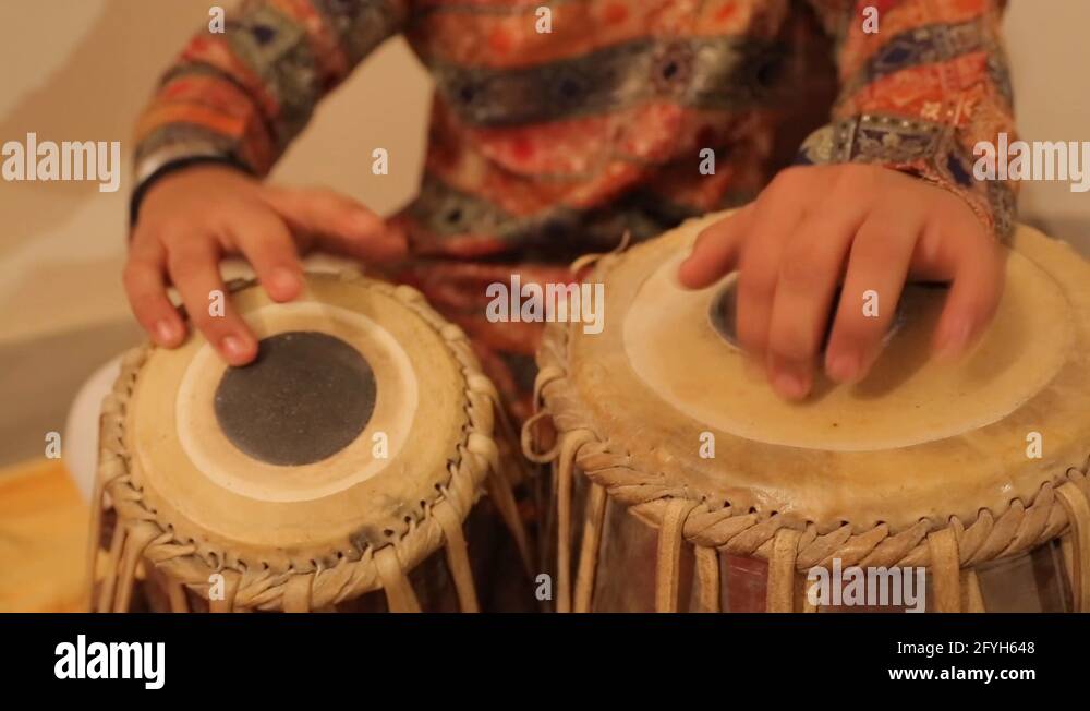 Man playing on a Bongo drum close up. Hand tapping a Bongo drum in