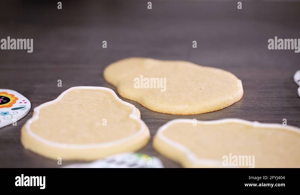 Creating edge for flooding sugar skull cookie with royal icing Stock