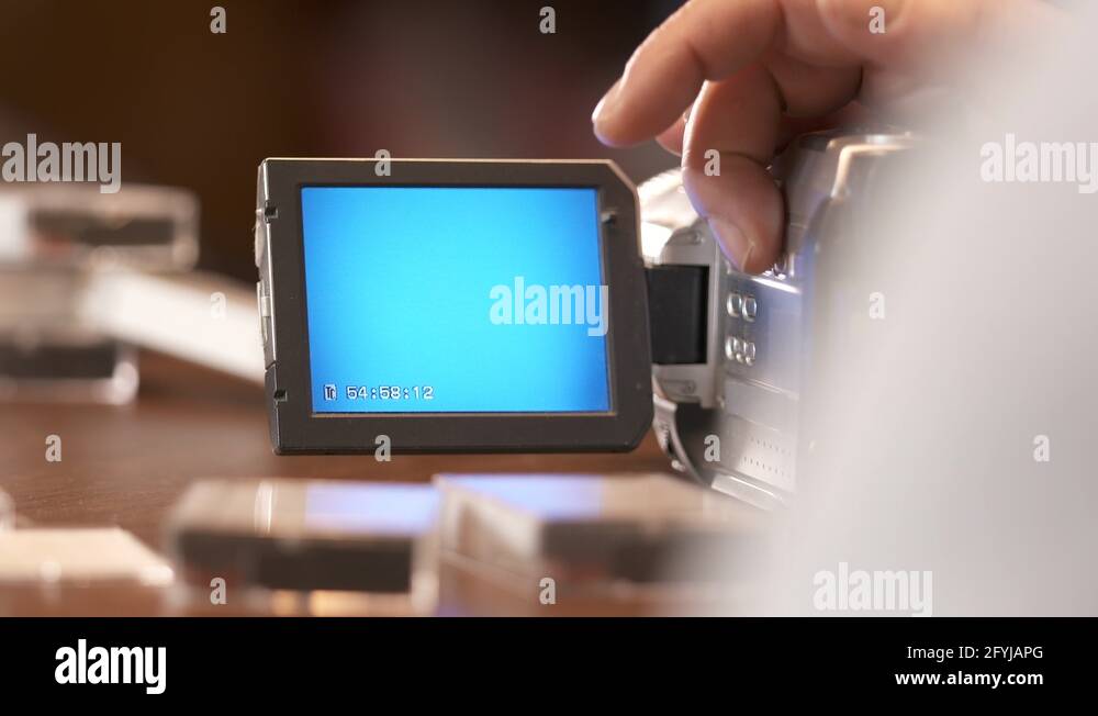 Man watching family home video on LCD screen of digital Mini DV camcorder Stock Video Footage