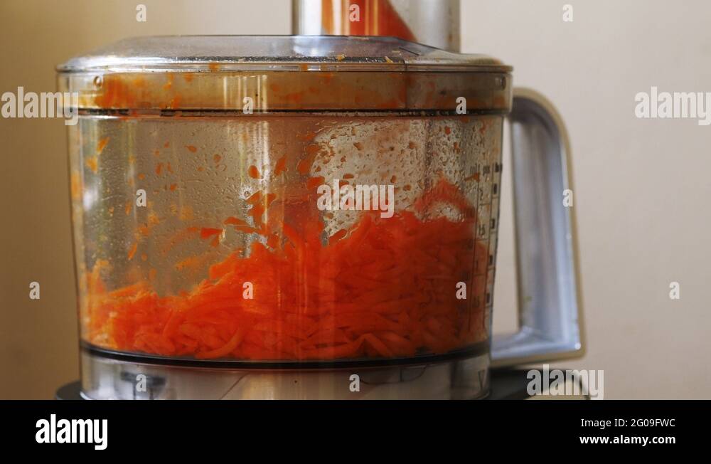 Grating carrots using a food processor Stock Video Footage Alamy