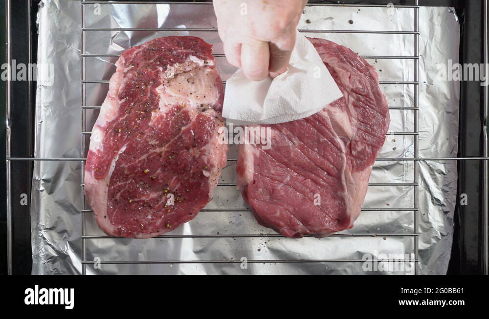 Cooking grilled steak ribeye in the oven with broiler top view Stock