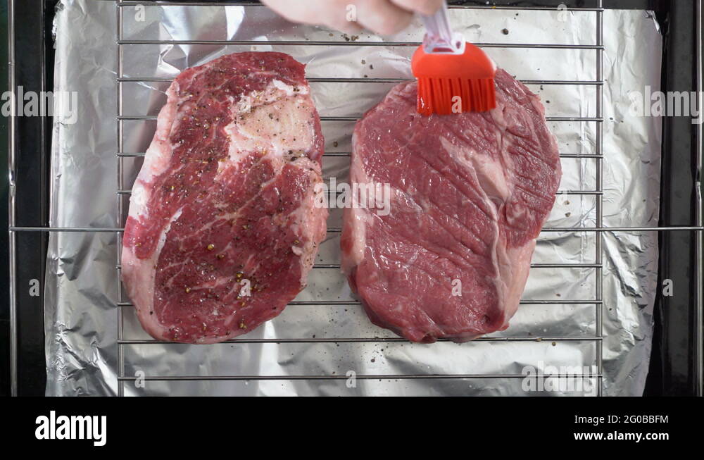 Cooking grilled steak ribeye in the oven with broiler top view Stock