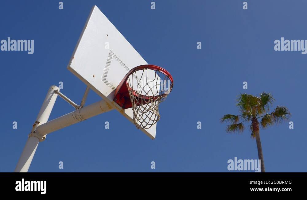 A man does a slam dunk while playing oneonone basketball hoops on a