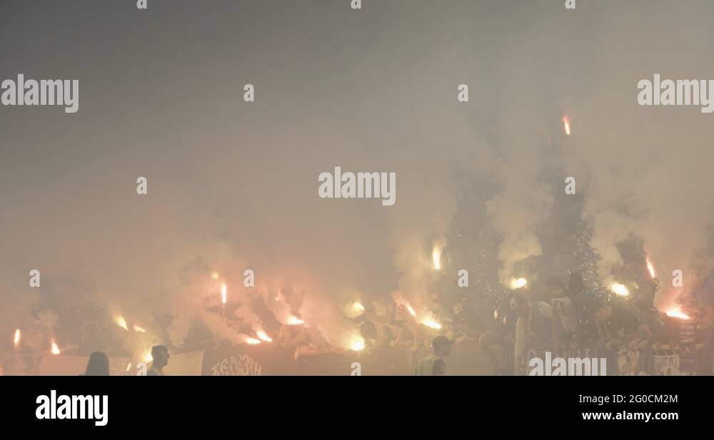 football fans burn fireworks with smoke and fire at the stadium Stock