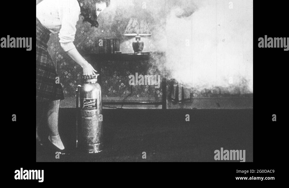 1940s UNITED STATES lady turns fire extinguisher upside down. Lady