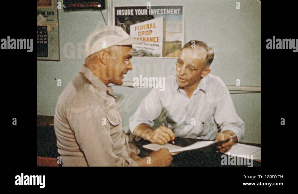 1950s Man in hat talks to man behind counter. Text "Quonset Grain