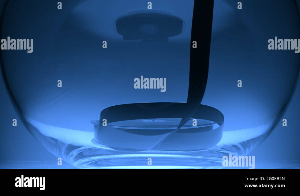 In the glass bowl lies a coil VHS and the tape pull up Stock