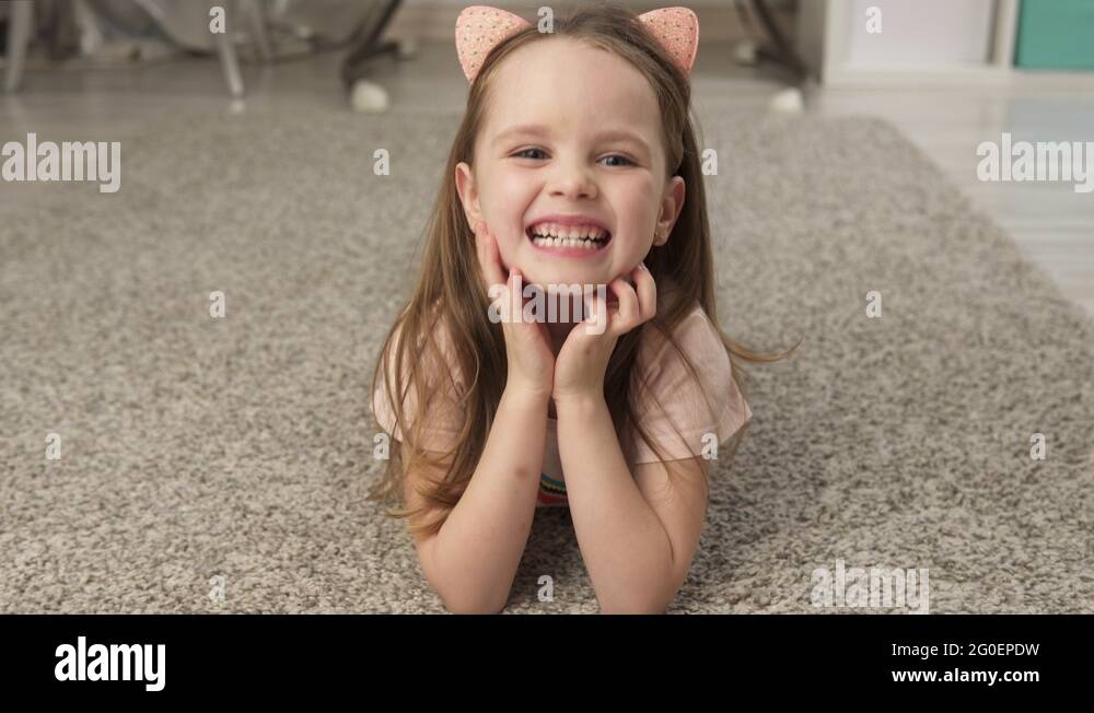 Cute little girl smiling while lying on the floor Stock Video Footage ...