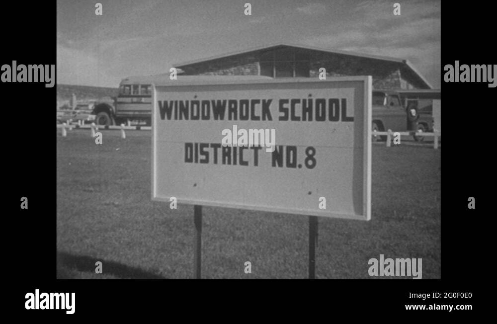1950s UNITED STATES Window rock School sign. School bus drives to