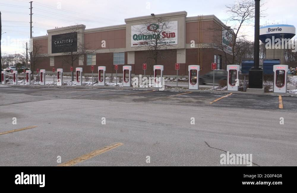 Tesla electric car charging gas station in Barrie Canada Stock Video