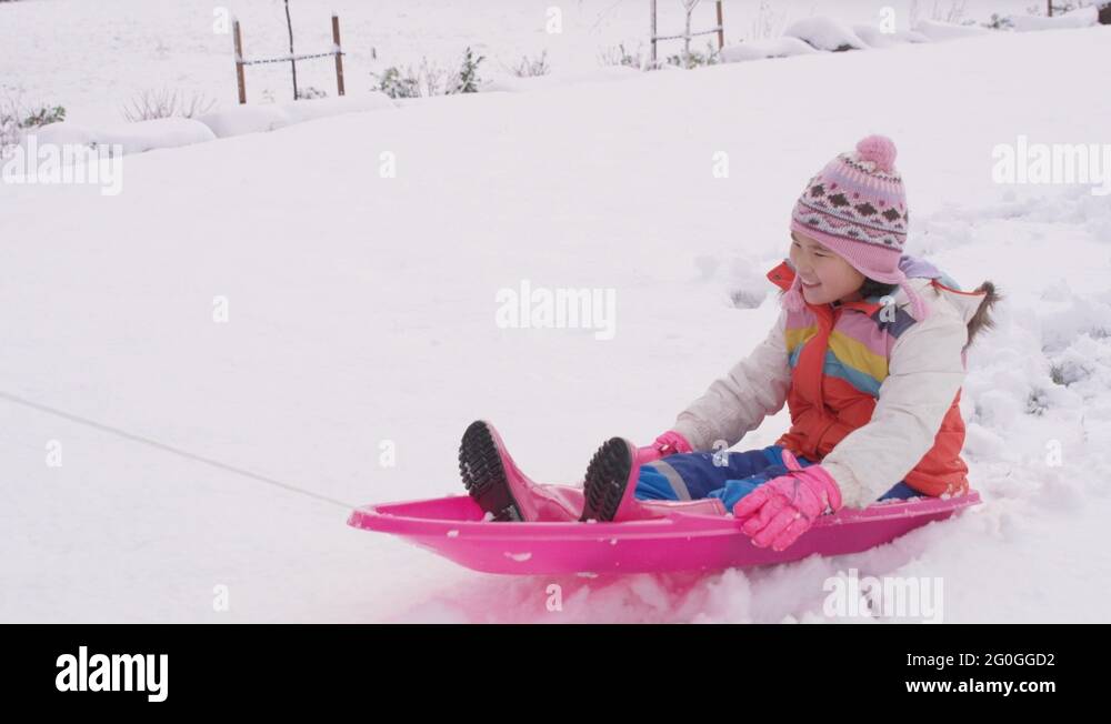 Kids playing and pushing sled in winter snow Stock Video Footage Alamy