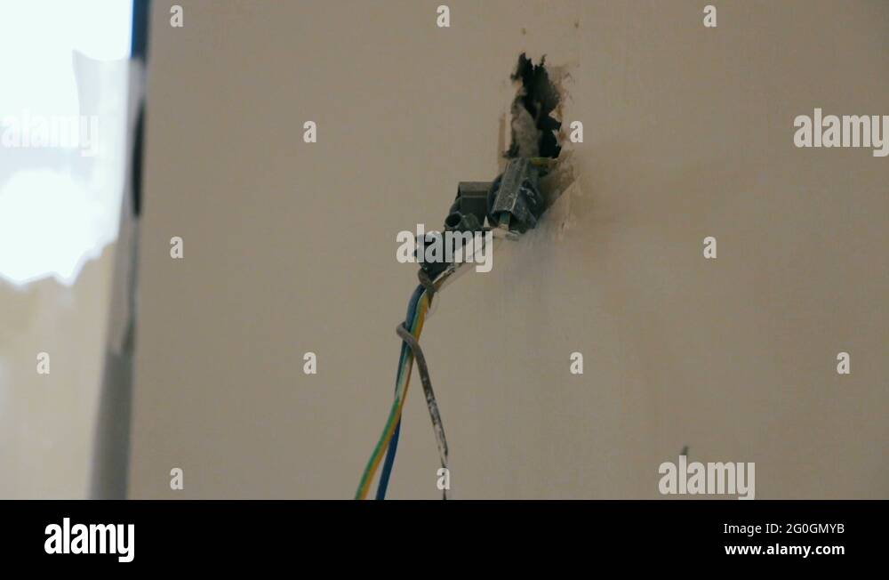 Electrical exposed wires protruding from socket on newly wall Stock