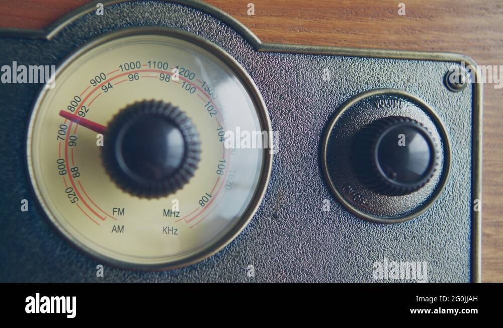 Knob turning for tuning the radio station and changing volume on a vintage radio Stock Video