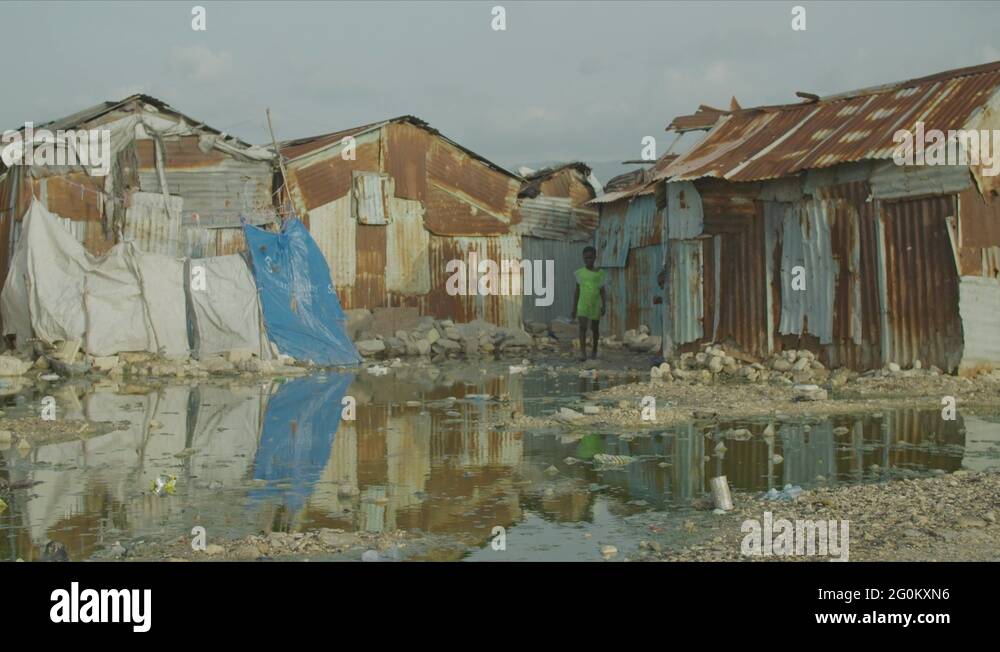 Young Kid Walking Around a Pool of Dirty Water in a Slum in Cité Soleil ...