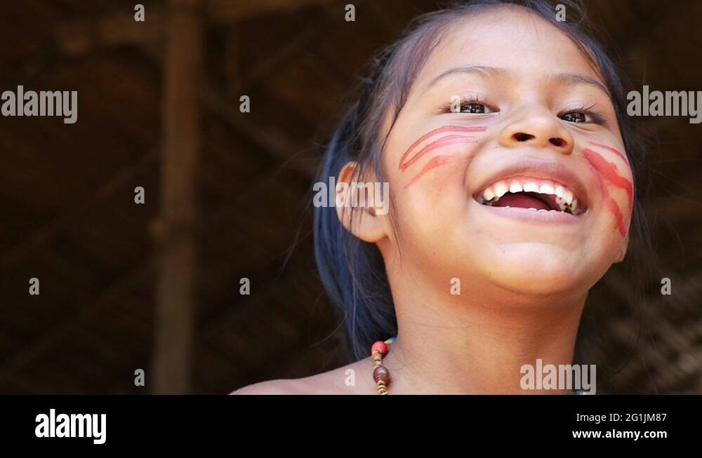 Native Brazilian girl looking to the camera at an indigenous tribe in ...