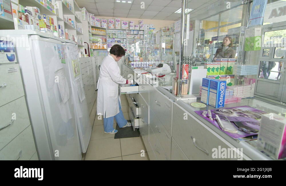 Pharmacy counter assistant serving customer Stock Videos & Footage - HD ...