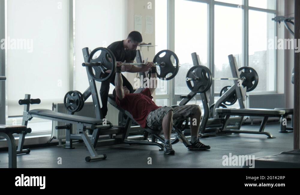Two bodybuilders does exercise with a bar in gym Stock Video Footage ...