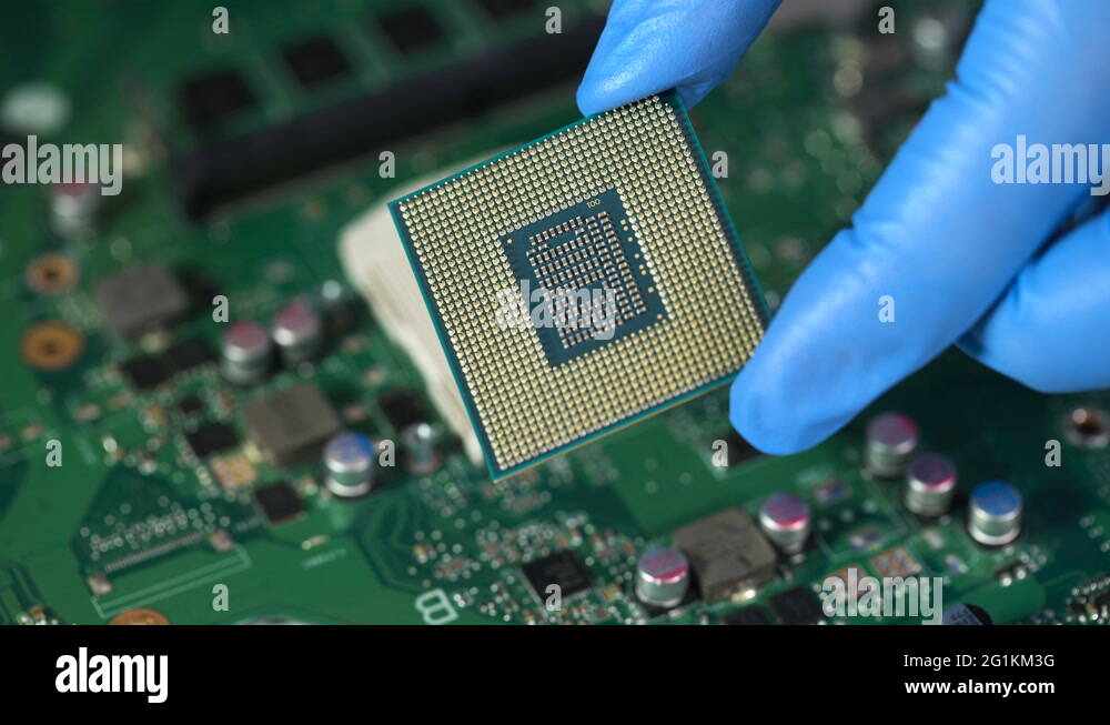 CPU in hand before installation into the motherboard Stock Video ...