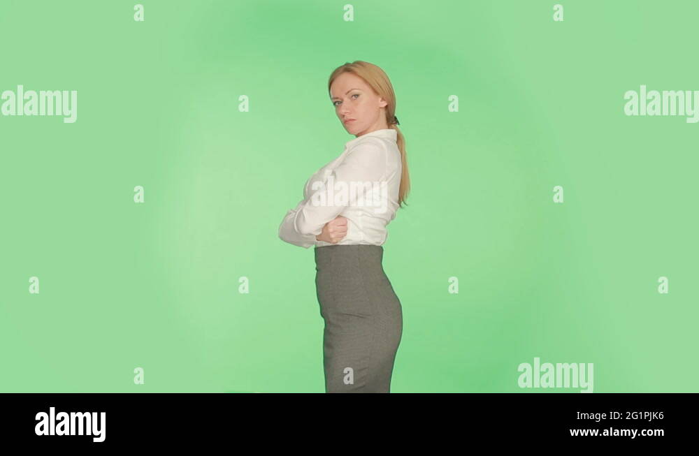 the body language of a woman on a green background, arms crossed