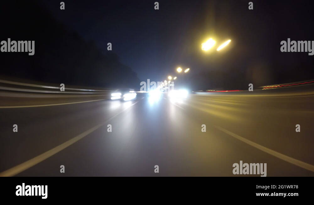 Night road POV through the city at night timelapse. View of the cars ...