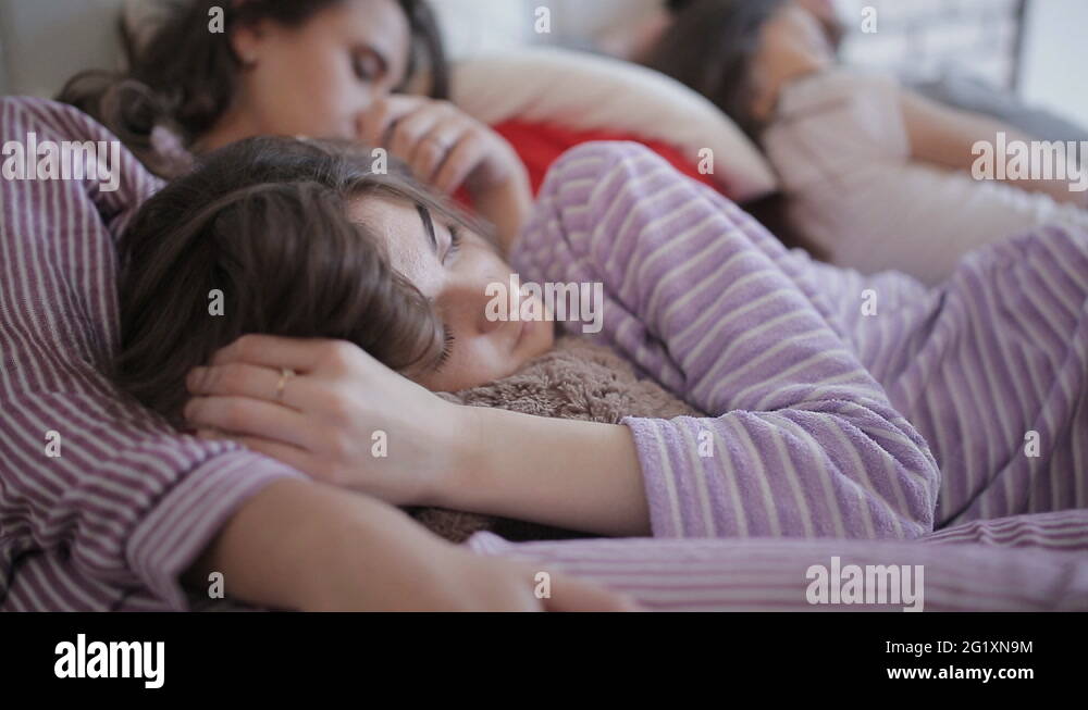 Friends tired after the party, sleeping together on the bed Stock Video ...