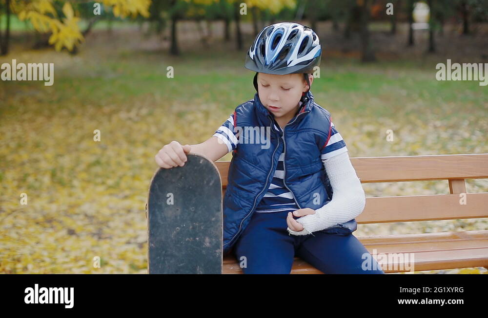 White boy with broken arm sitting with skate Stock Video Footage Alamy