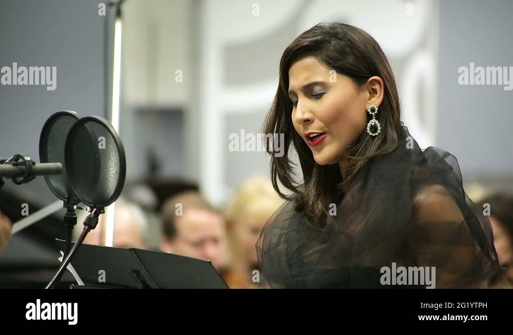 Opera singer sings in the microphone with the orchestra Stock Video