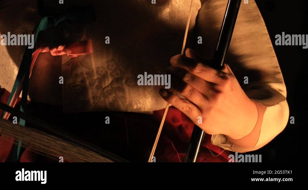Korean female musician playing the Haegeum, Korean traditional string