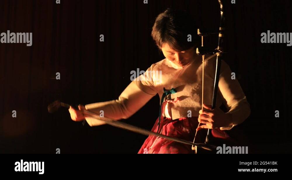 Korean female musician playing the Haegeum, Korean traditional string
