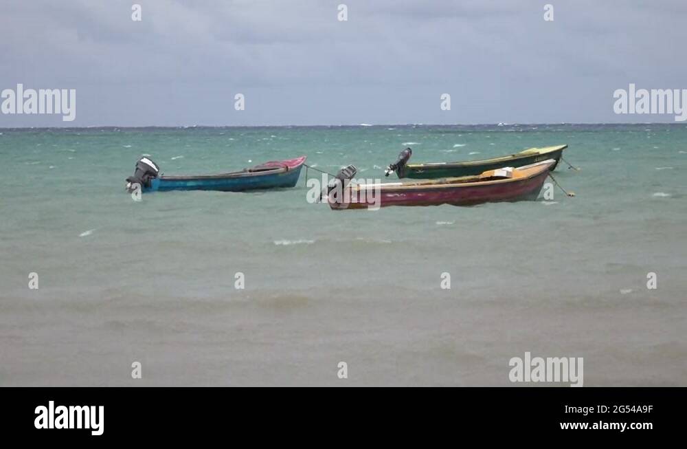 Jamaica beach Caribbean coastal village fishing boats 4K Stock Video