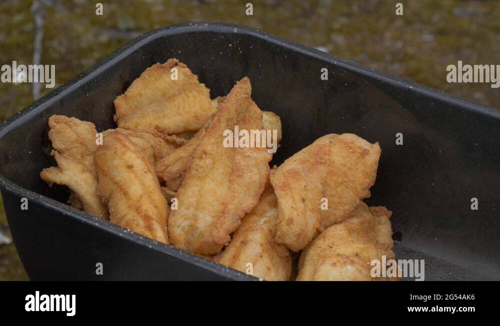 Fried fish in a saucepan Stock Video Footage Alamy
