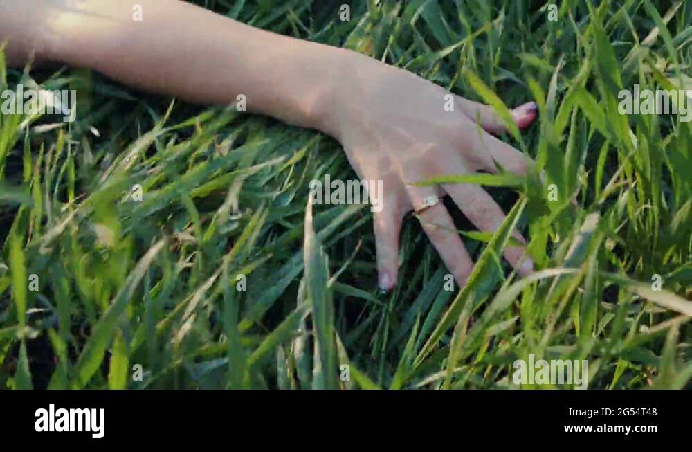 Close up side view of a young woman arm and hand laying down and