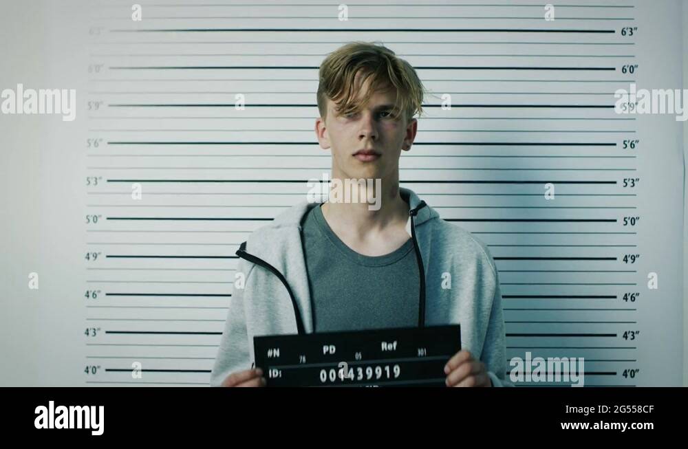 Police Station Arrested Teenage Delinquent Poses For Side Front View Mugshot Stock Video Footage Police Station Arrested Teenage Delinquent Poses For Side Front View Mugshot Stock Video Footage