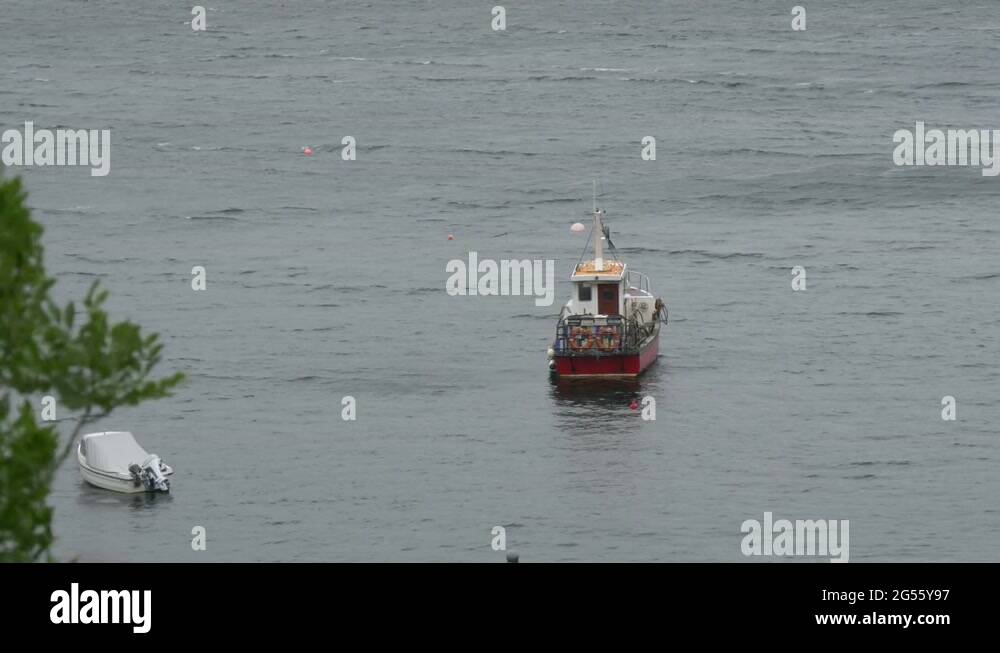Two anchored boats floating on water Stock Video Footage Alamy