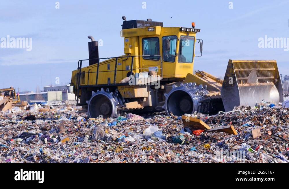 A landfill compactor working at landfill. Waste, garbage, dump, rubbish