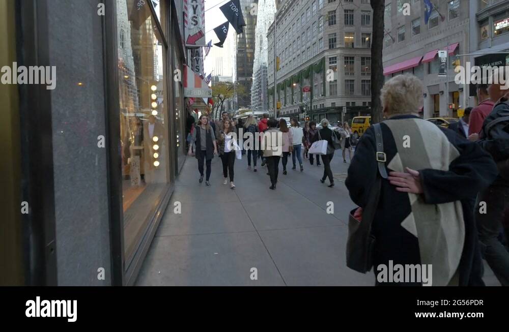 People walking by the Friday's restaurant Stock Video Footage Alamy