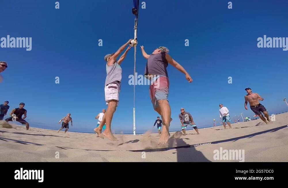 POV of senior men playing beach volleyball, slow motion Stock Video