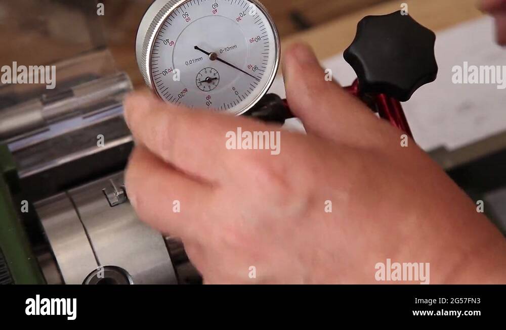 man using micrometer clock precision dial test indicator gauge scale on