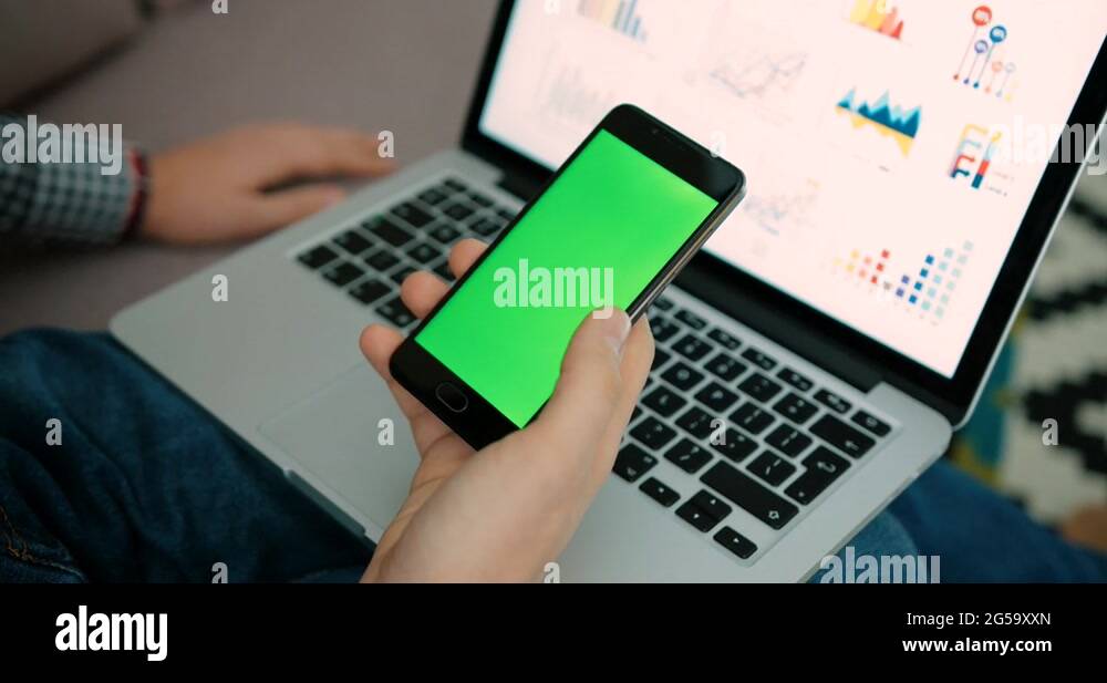 Close up man hands holding smart phone with green screen. Chroma Key ...