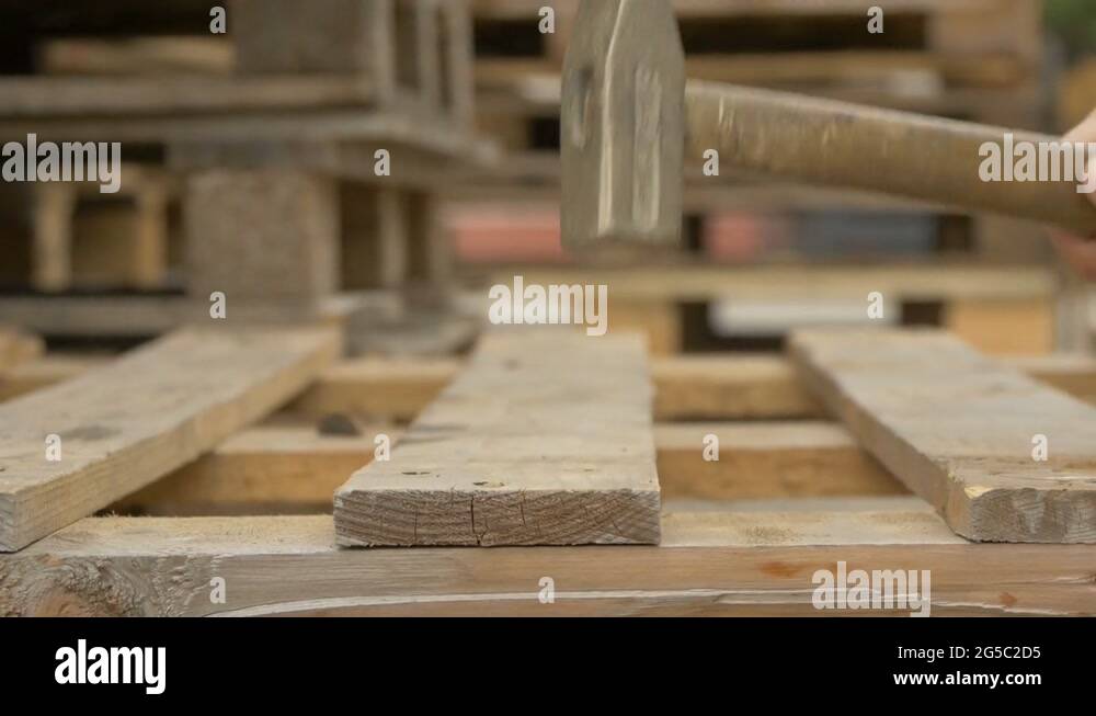 Nailing wooden pallets Stock Video Footage Alamy