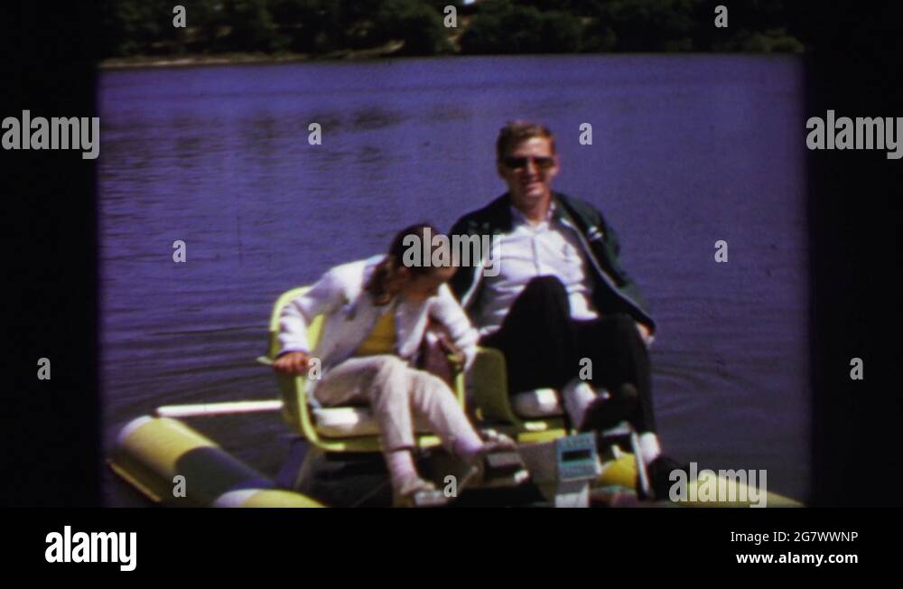 LYNBROOK NEW YORK1971 Old Man And Young Girl Paddling On Water Stock