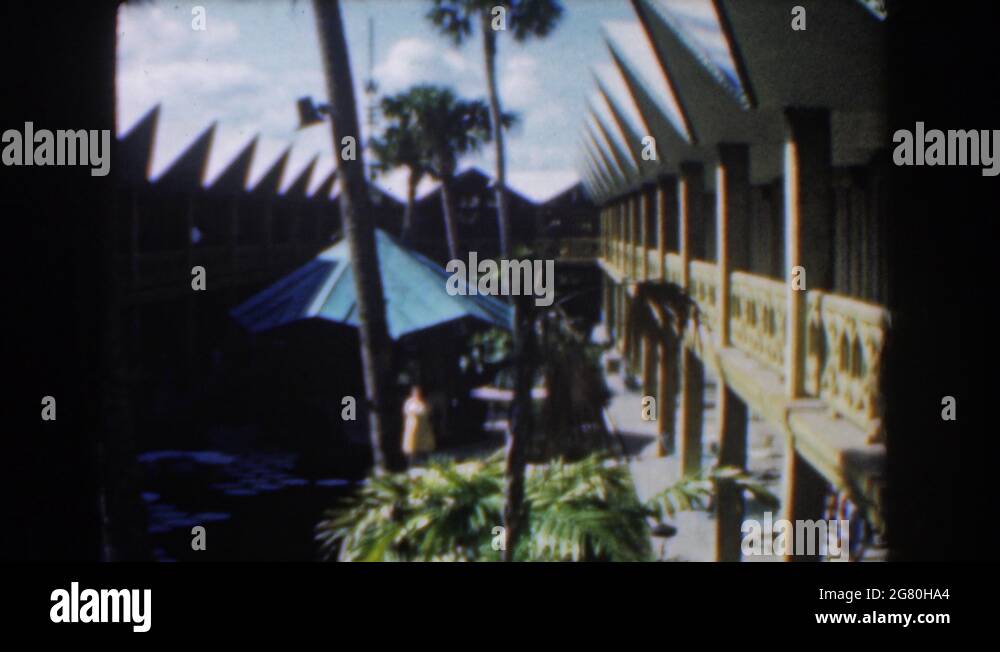 NASSAU BAHAMAS1961 View Of Green Patio Umbrella And White Building On A Clear Stock Video