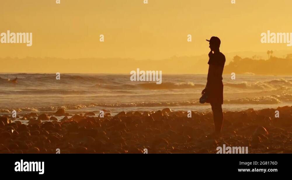 Cinemagraph - Silhouette man standing ocean beach waves sunset 4K
