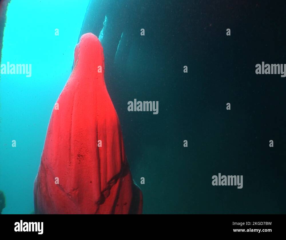 mother mary statue underwater air plane wreck scuba diver scooter Stock